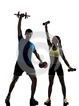 Woman exercising fitness workout with man coach silhouette