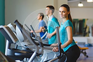 Woman exercising at the gym on a cross trainer