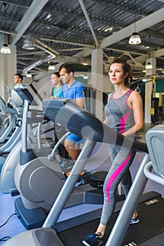 Woman exercising at the gym on a cross trainer