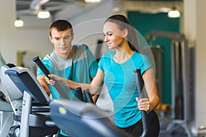 Woman exercising at the gym on a cross trainer