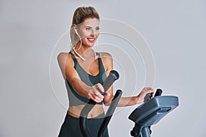 Woman exercising at the gym on crosstrainer