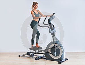 Woman exercising at the gym on crosstrainer