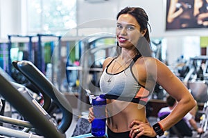 Woman exercising at the gym in an elliptical trainer Cardio training.