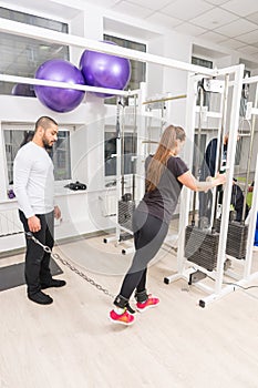 Woman exercising at gym using cable machine