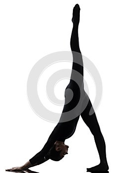 Woman exercising gymnastic yoga Adho Mukha Svanasana silhouett photo