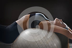 Woman exercising her abs on a Pilates fit ball