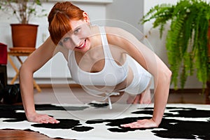 Woman is exercising at home