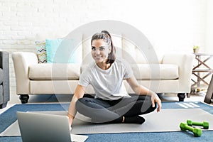 Woman exercising at home watching online videos