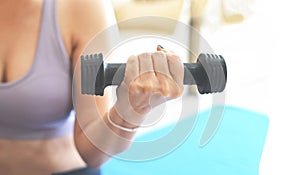 woman exercising at home, woman dumbbells in her hands, sporty woman exercise muscles in sportswear with dumbbell at home in the