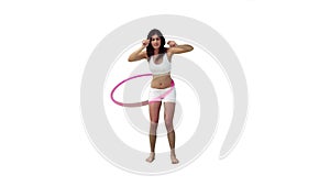 A woman is exercising with a hula hoop