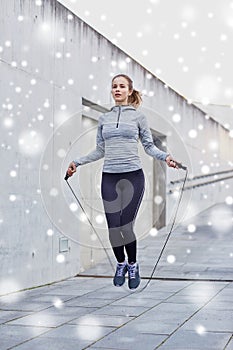Woman exercising with jump-rope outdoors
