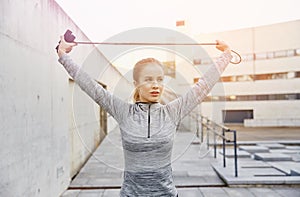 Woman exercising with jump-rope outdoors