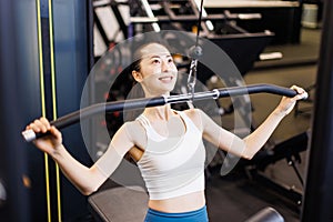 woman exercising on lat pulley