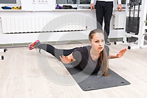 Woman exercising legs on cable crossover machine