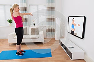 Woman Exercising In Living Room