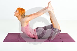 Woman exercising on mat