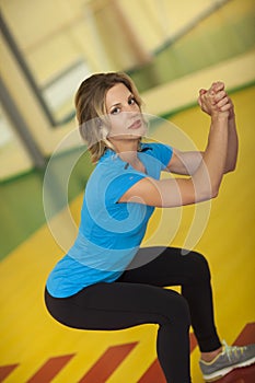 Woman exercising on mat in fitness class. Female workout