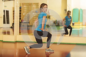 Woman exercising on mat in fitness class. Female workout