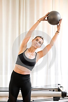Woman exercising obliques doing standing yoga pose