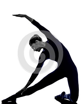 Woman exercising parighasana gate pose yoga silhouette