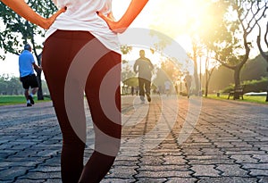 Woman exercising in the park with sunlight