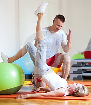 Woman exercising with personal trainer