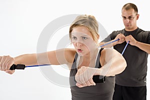 Woman exercising with personal trainer photo