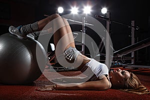 Woman exercising Pilates ball