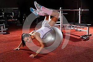 Woman exercising Pilates ball