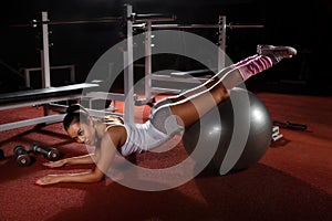 Woman exercising Pilates ball