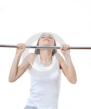 Woman exercising on pull-up bar