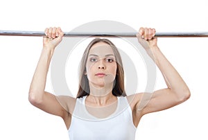 Woman exercising on pull-up bar