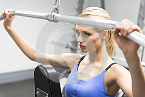 Woman Exercising With Pulley In Gym