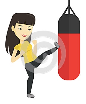 Woman exercising with punching bag.