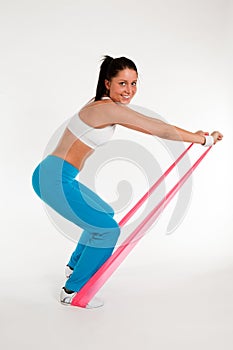 Woman exercising with rubber ribbon