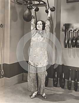 Woman exercising in silk pajamas