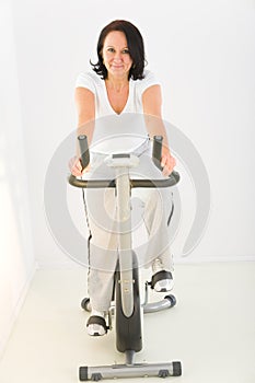 Woman exercising on spinning bike