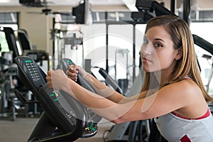 Woman Exercising On Stationary Cycle