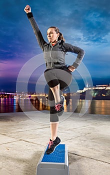 Woman exercising on steeper photo