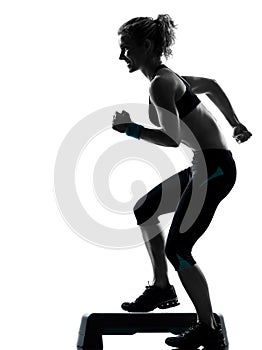 Woman exercising step aerobics