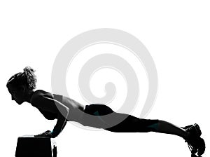 Woman exercising step aerobics