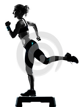 Woman exercising step aerobics