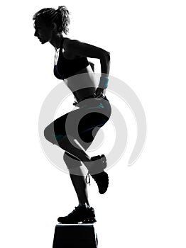 Woman exercising step aerobics