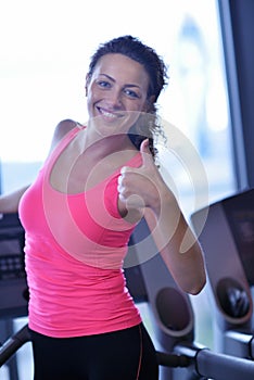 Woman exercising on treadmill in gym