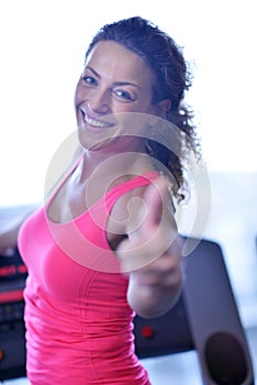 Woman exercising on treadmill in gym