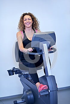 Woman exercising on treadmill in gym