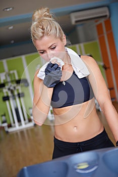 Woman exercising on treadmill in gym