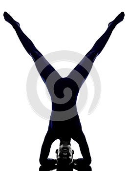 Woman exercising vrschikasana scorpion pose yoga