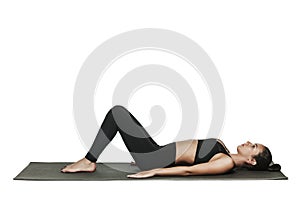 Woman exercising on yoga mat. Isolated on white.
