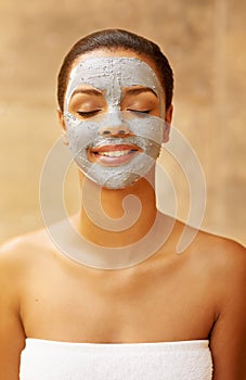 Woman, exfoliate and mud mask at spa, facial treatment and detox or cleaning dermatology. Female person, self care and photo